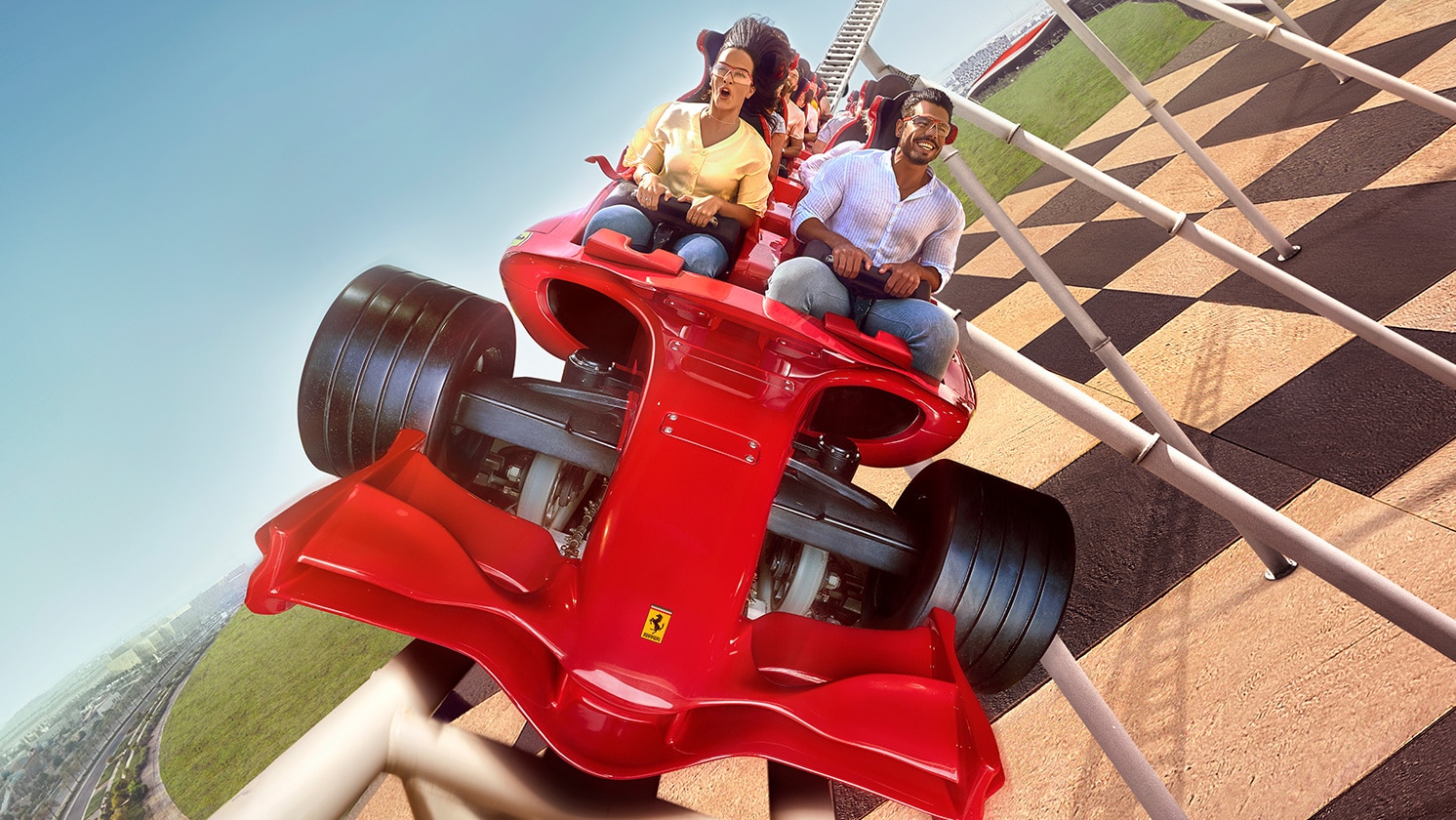 Formula Rossa 过山车的红色列车在发射段加速，远处可见红色屋顶建筑